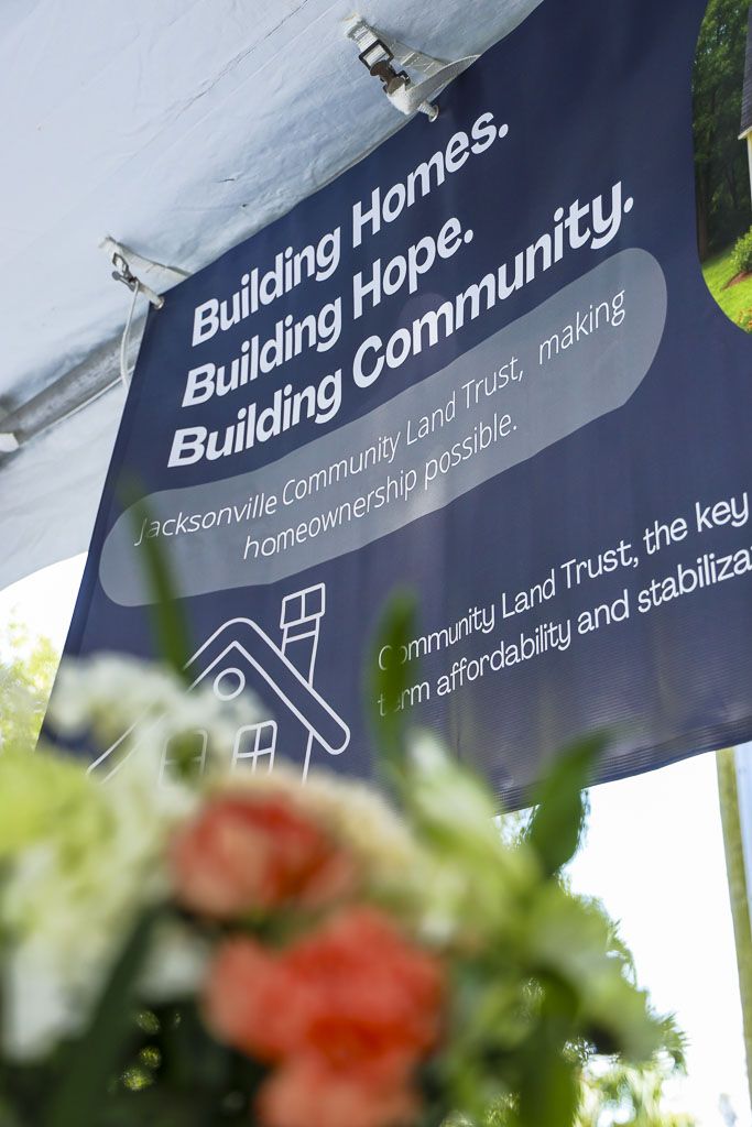 Event banner reading Building Homes, Building Hope, Building Community